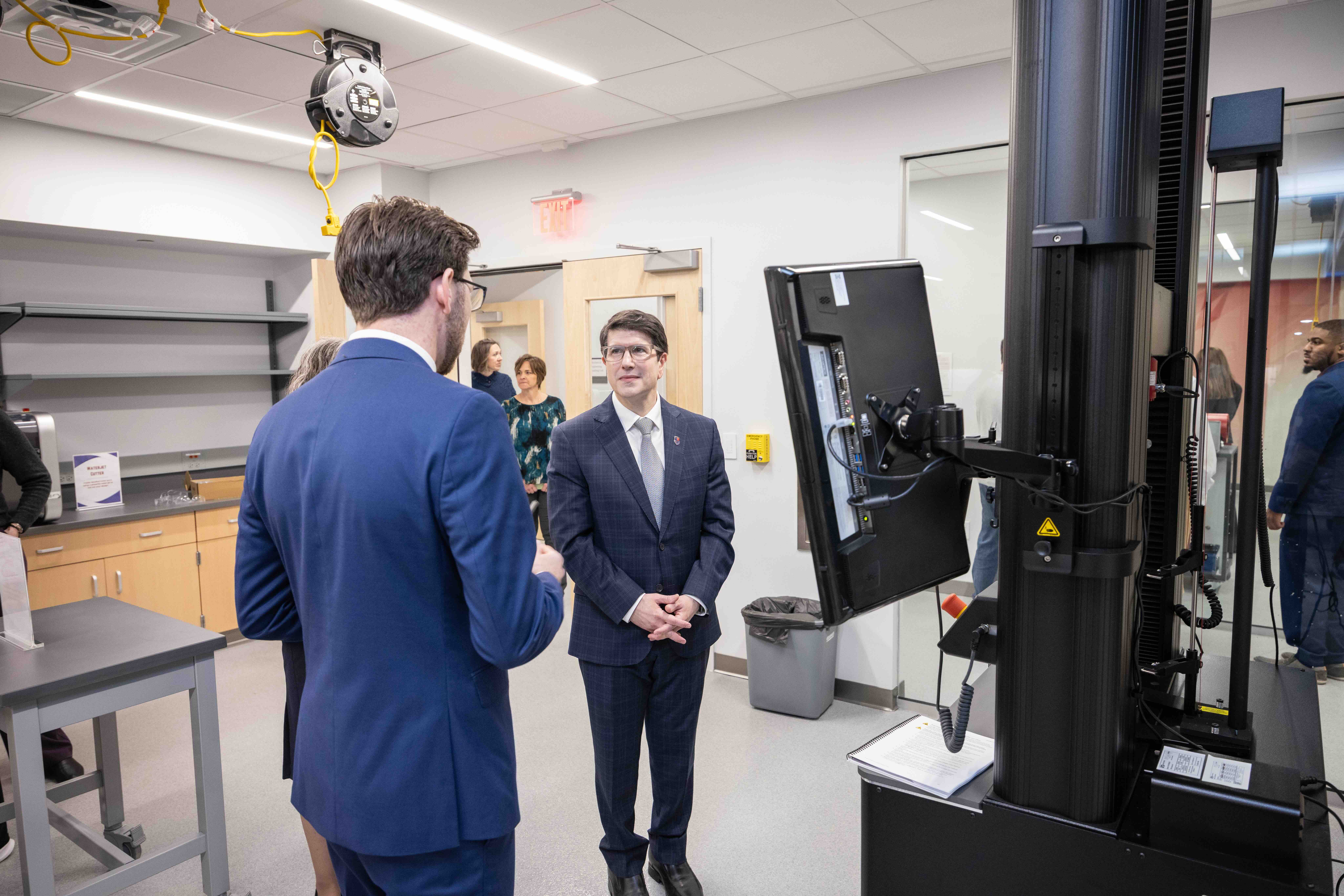two males in front of a computer in a lab