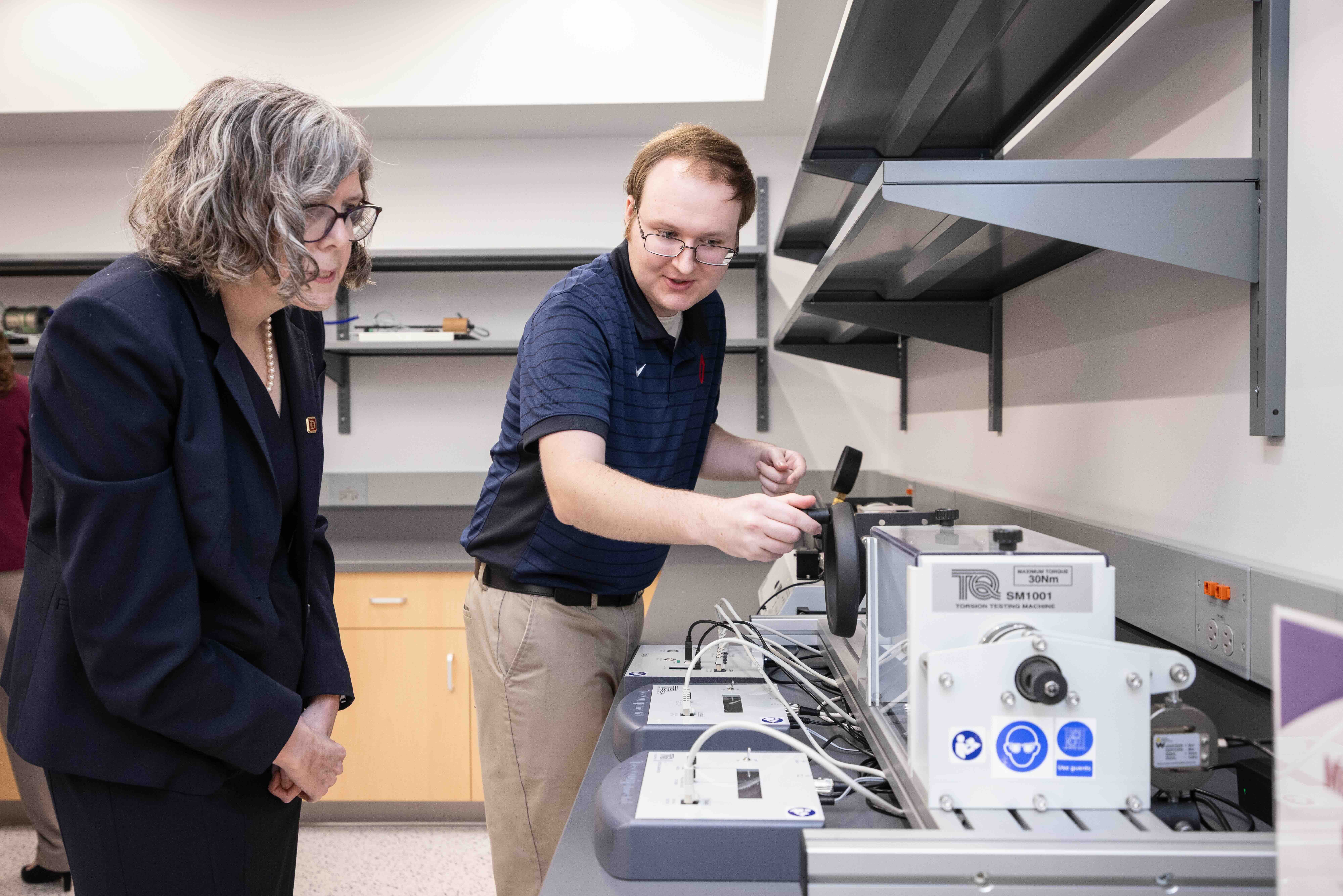 two people looking at a piece of equipment