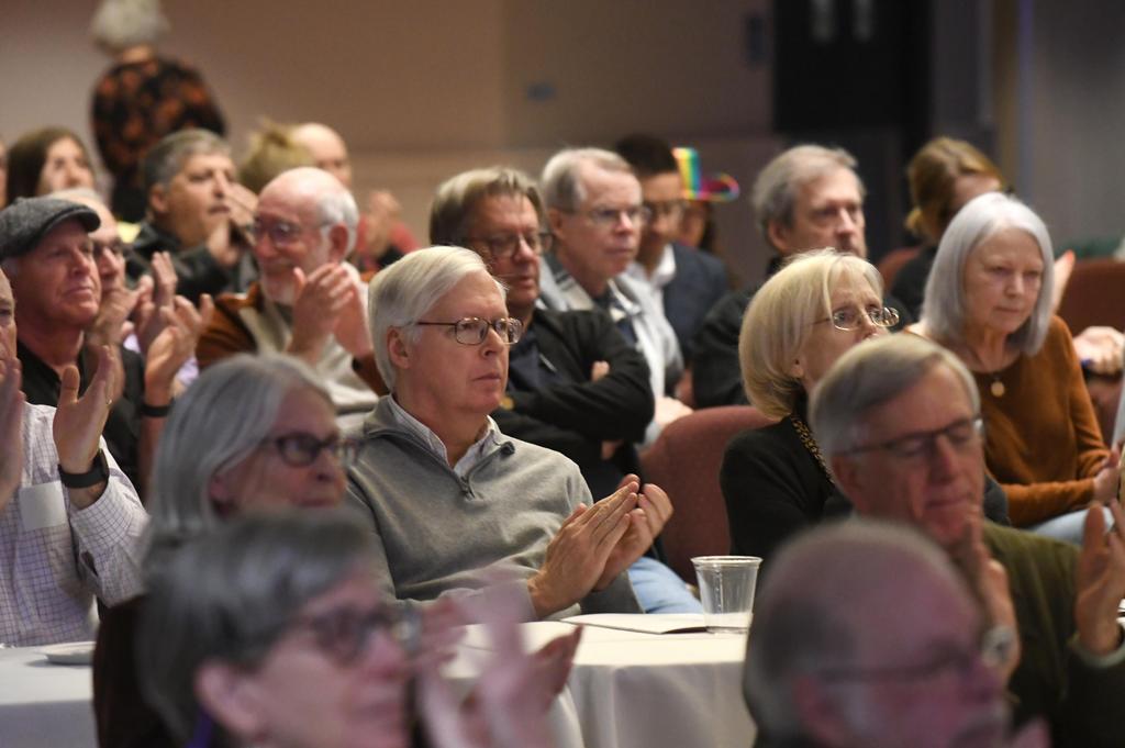 a man clapping in an audience