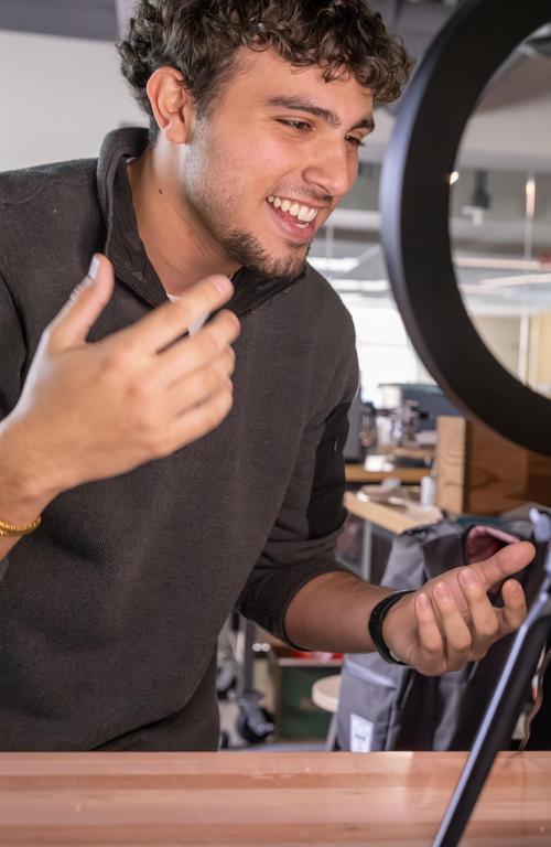 student smiling at phone