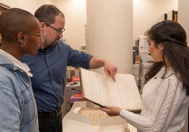 Archivist reviewing book content.