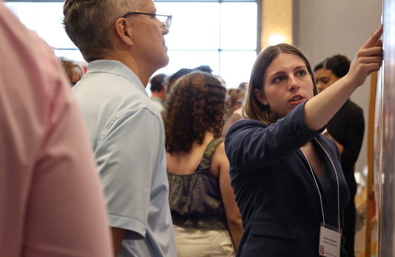Madison Fitzgerald pointing at a presentation.