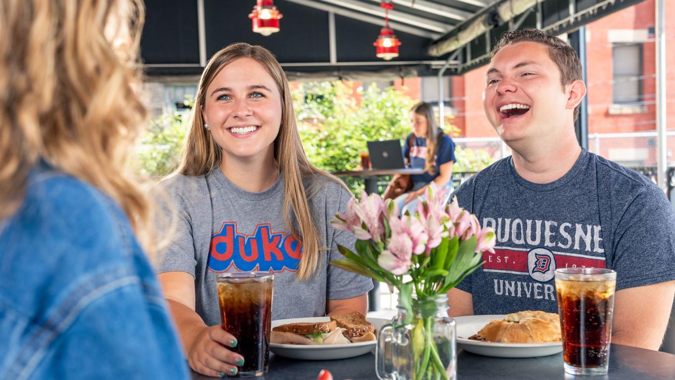 Students laughing at table