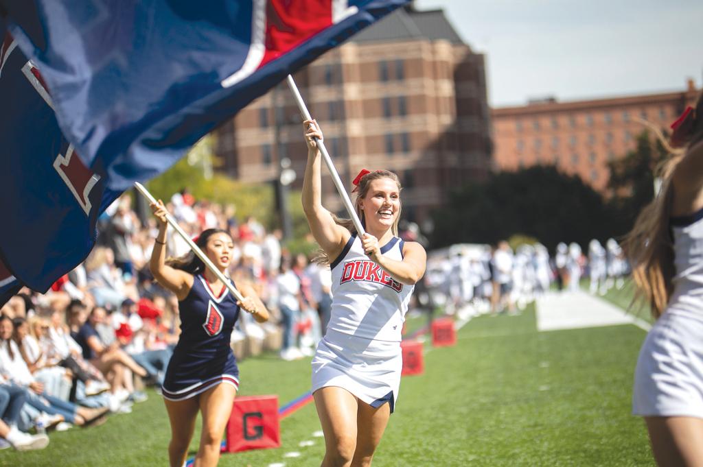 students with Duquesne flags at a sporting event