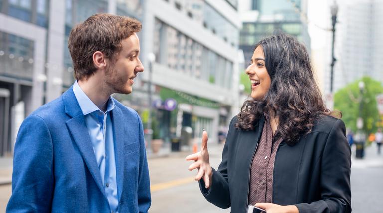 Duquesne students in suits talking in downtown Pittsburgh