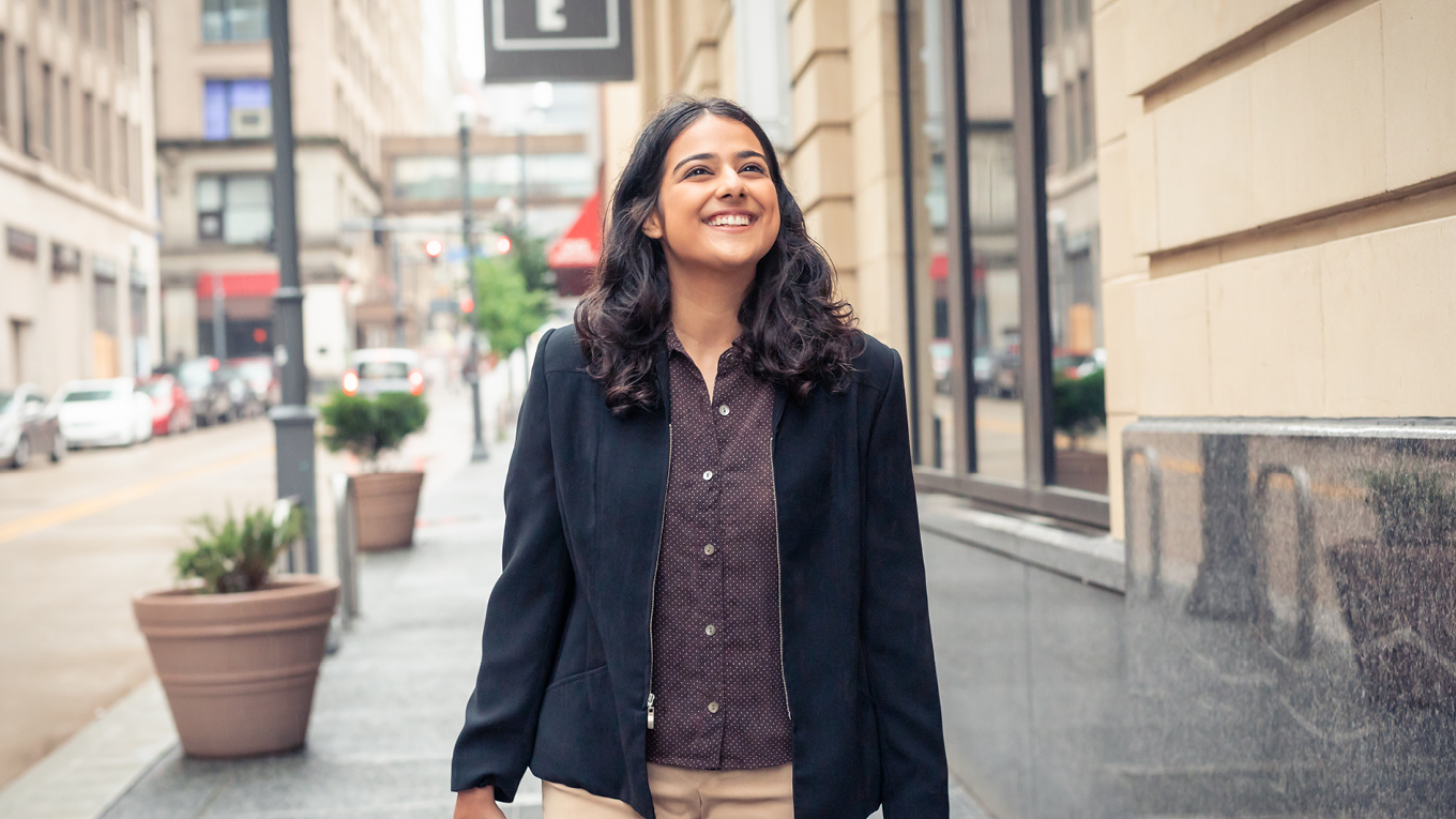 Duquesne student walking on city street in Pittsburgh