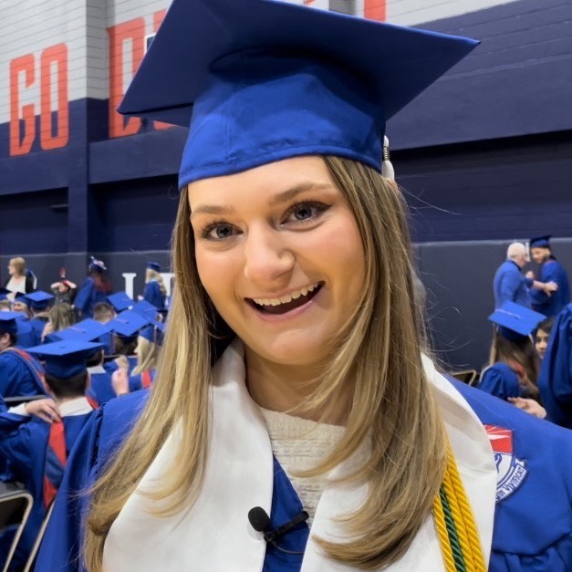 Student Samantha Vail in commencement robe at ceremony