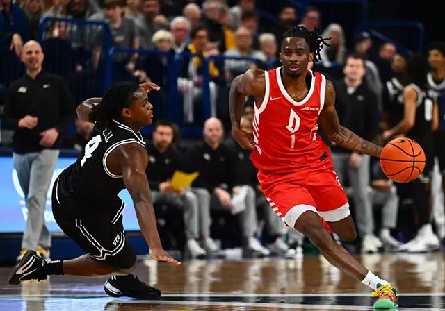 Duquesne's Tarance Guinyard dribbles up the court.