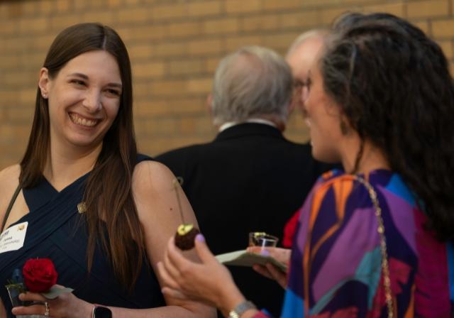 A woman laughs with another person