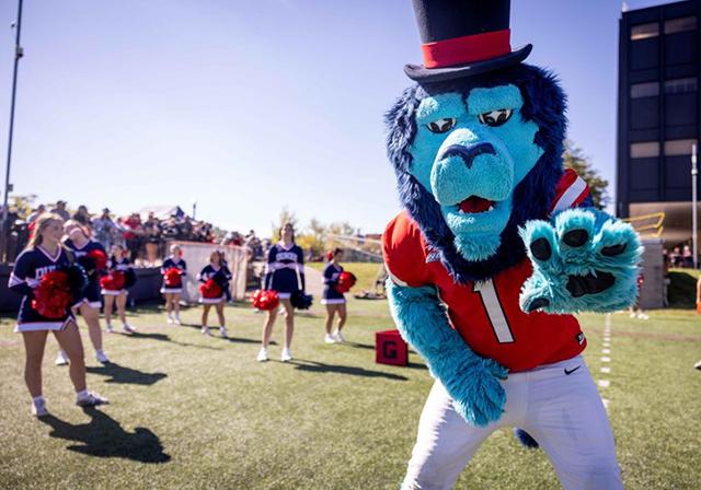 Cheerleaders and mascot at Homecoming