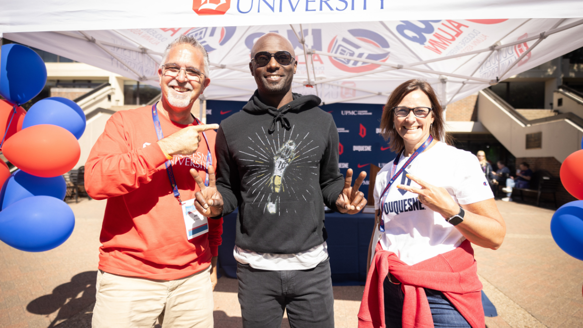 Santonio Holmes, Jr. with two other people