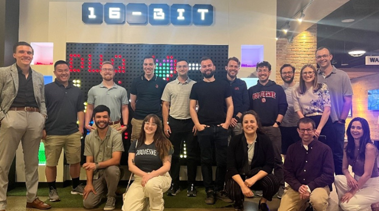a group of people at a bar smiling