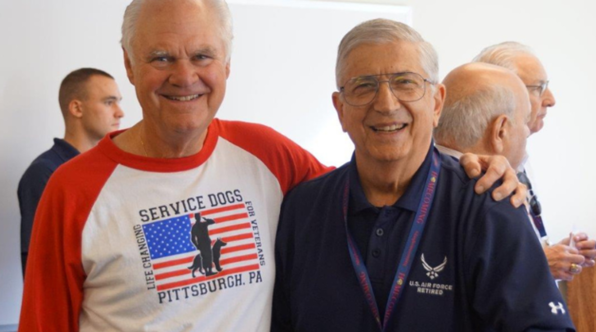 Two men standing together smiling