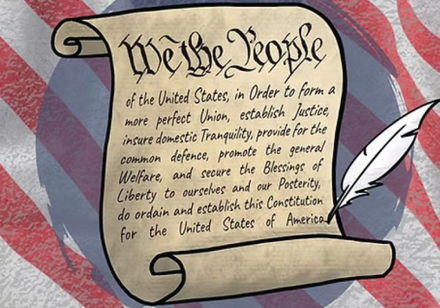 A scroll of the Constitution with an American flag behind it. 