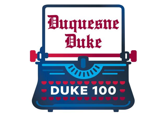 Typewriter with Duke 100 written on the page.