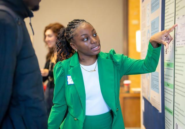Undergraduate student presenting her poster. 