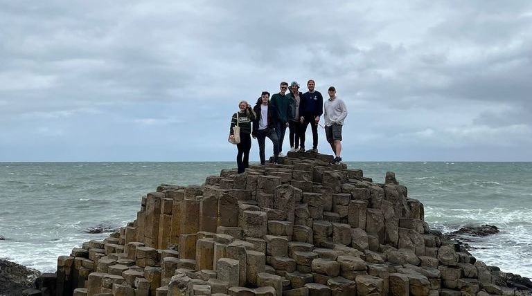 Students standing on rocks in Ireland