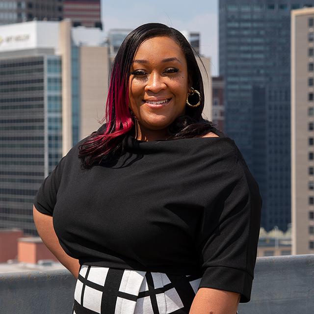 Amber Satterwhite headshot with city in background