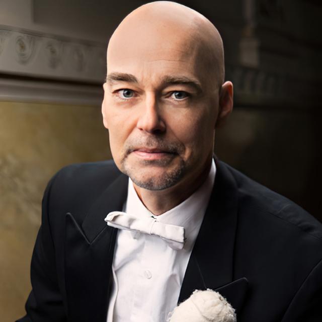 Christopher Allen in a tuxedo with a percussion mallet.