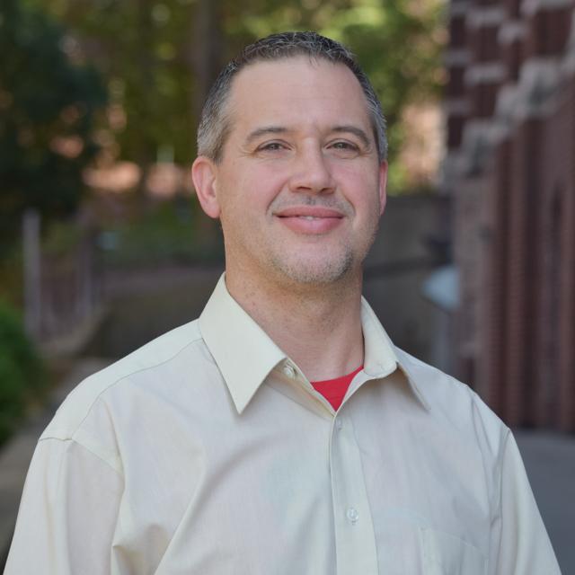 Headshot of Dr. Christopher Meidl outside Canevin Hall