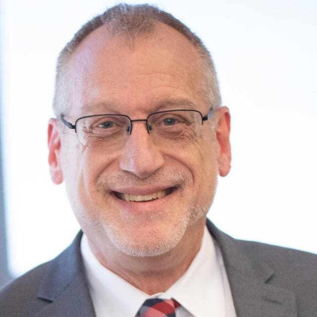 David Allen Wehr poses for a headshot in front of a white background.