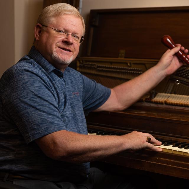 David Barr tunes a piano.