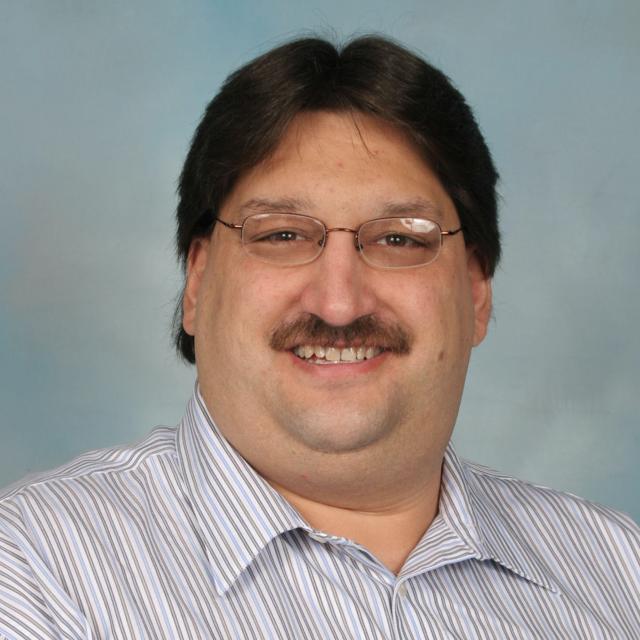 Headshot of Dr. David Delmonico in studio