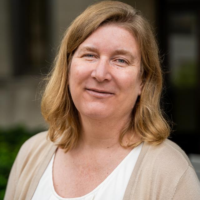 Elaine Abbott poses for a headshot outdoors.