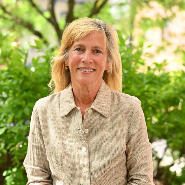 Headshot of Dr. Serenka outside with campus trees in background