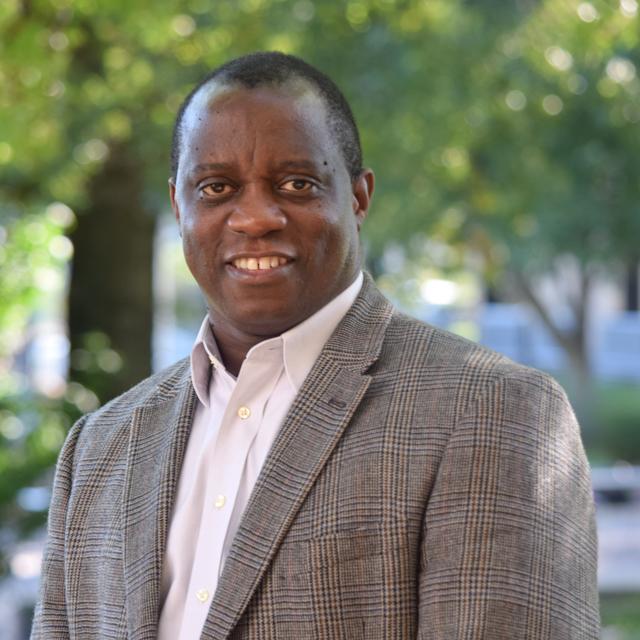 Headshot of Dr. Gibbs Kanyongo on campus with trees behind him