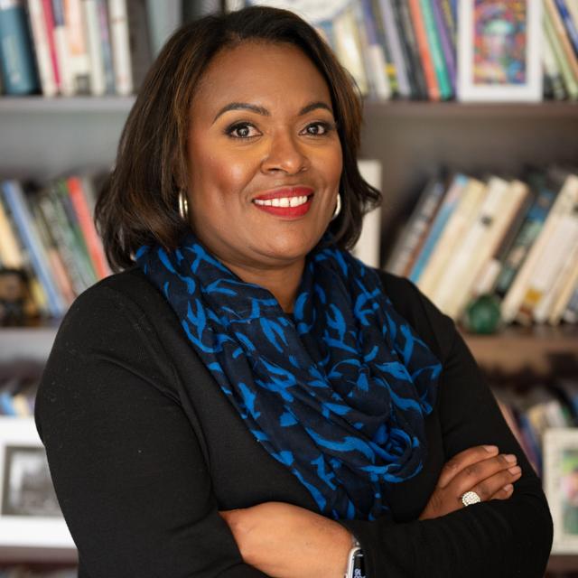 Gretchen Generett headshot with bookshelf in background