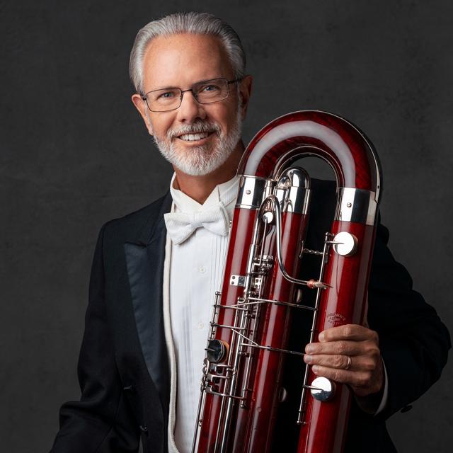 James Rodgers in a tuxedo with a contrabassoon.