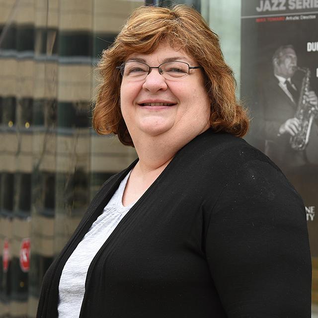 Jane Cubbison poses for a headshot outdoors.