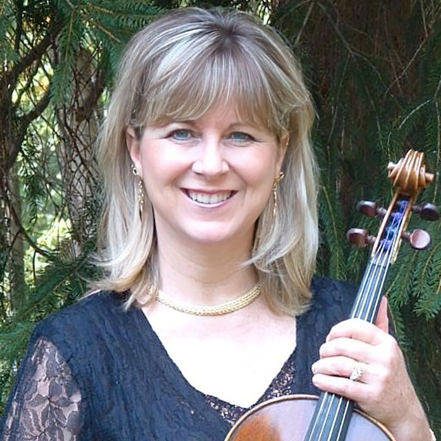 Jennifer Gerhard poses with viola in front of a tree.