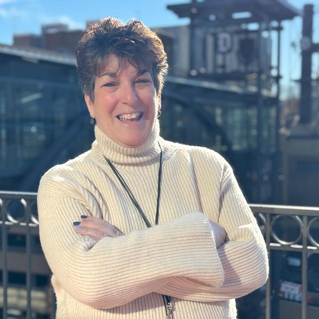  Headshot of Dr. Levitt with Duquesne skywalk with D emblem on it and campus buildings in background