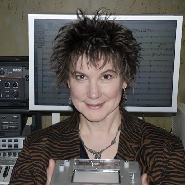 Lynn Purse poses for a photo in a music technology studio.