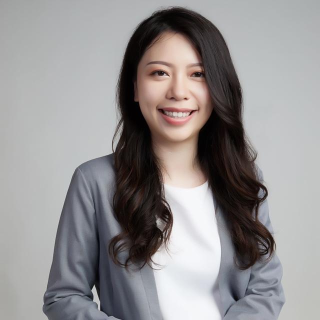 Meng-Shan Lee poses for a headshot in front of a gray background.