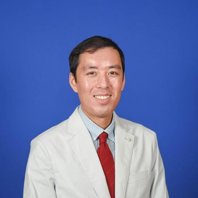 Nathan Ong wears a suite and smiles in this headshot.