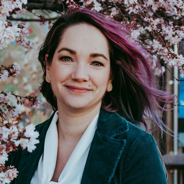 Stephenie Sofield poses for a headshot outdoors.