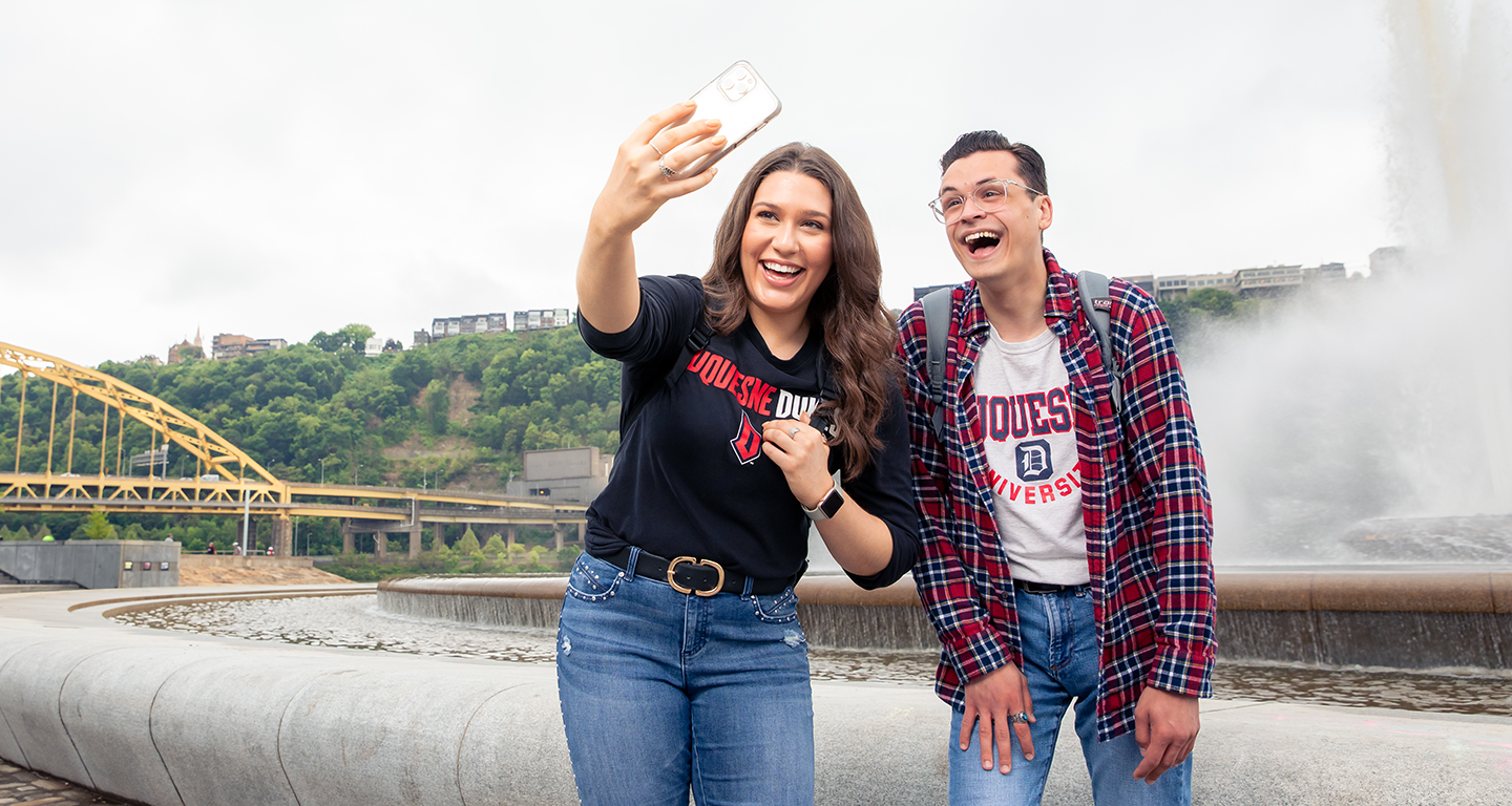 students at the point taking a selfie.
