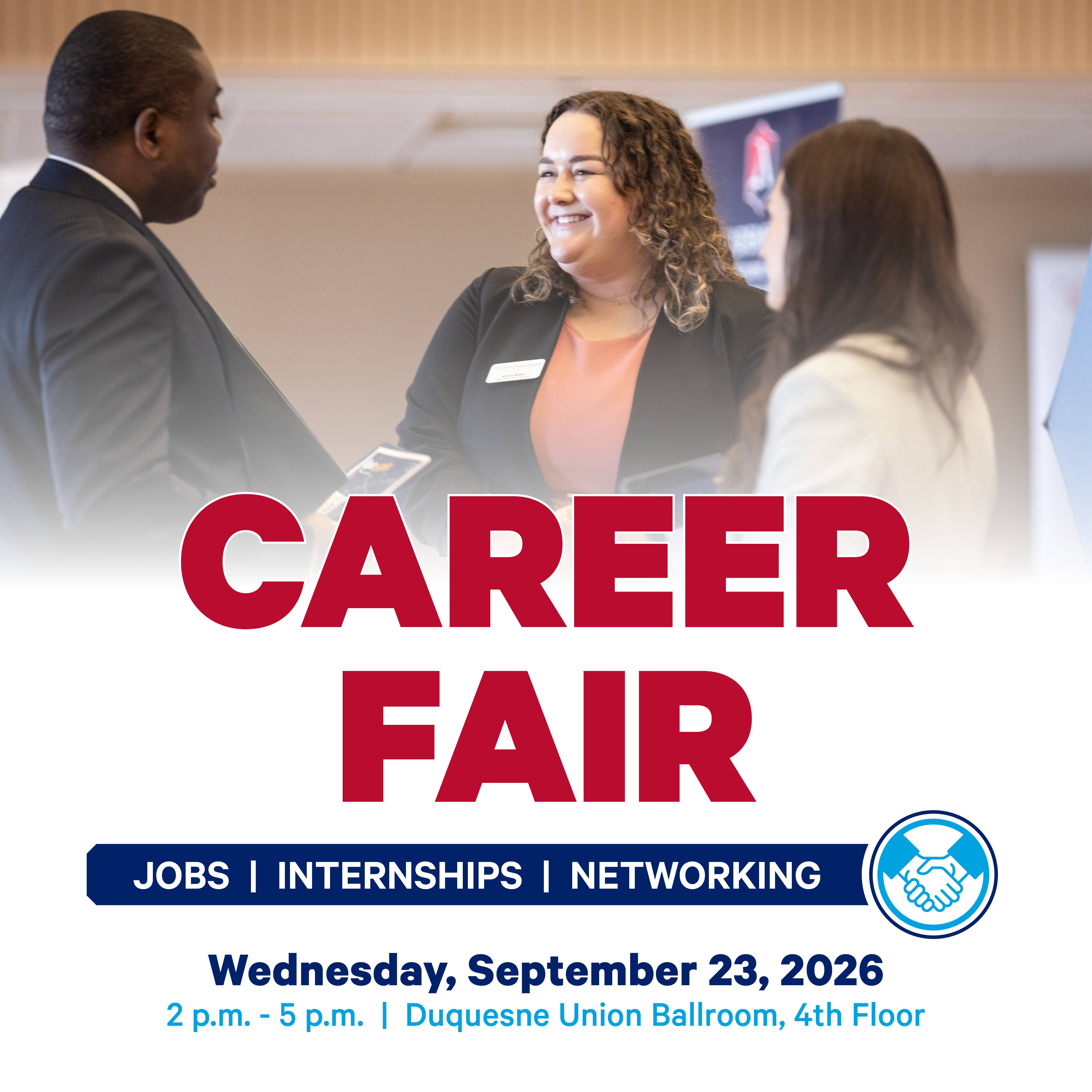 Recruiters and students are dressed professionally, smiling and conversing at a past Duquesne Career Fair in the Union Ballroom.