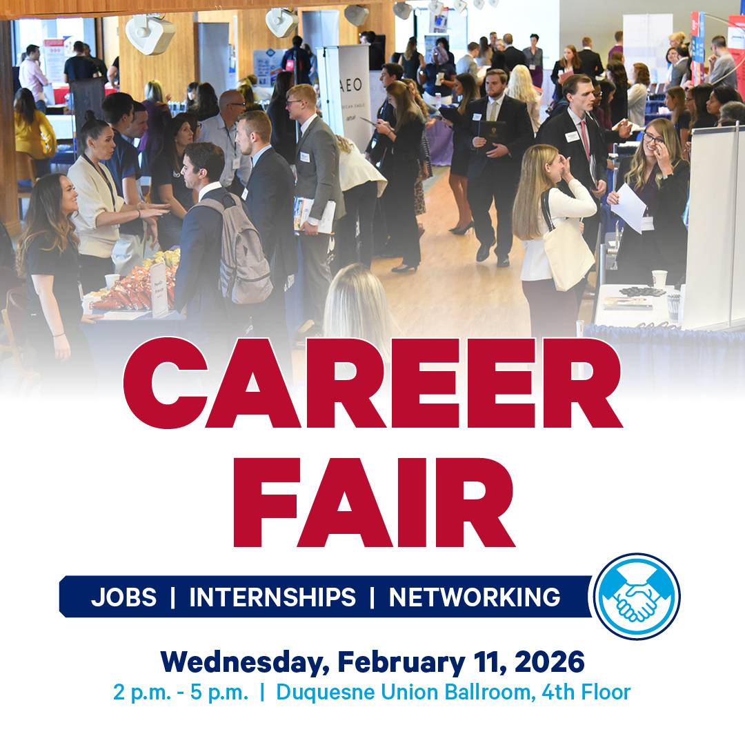 Birdseye view of a past Duquesne career fair in the Union Ballroom with several professionally dressed students and employer representatives walking around and interacting.  