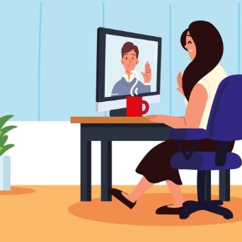 Clip art image of a female sitting at a desk interacting with a male via video on a laptop screen.