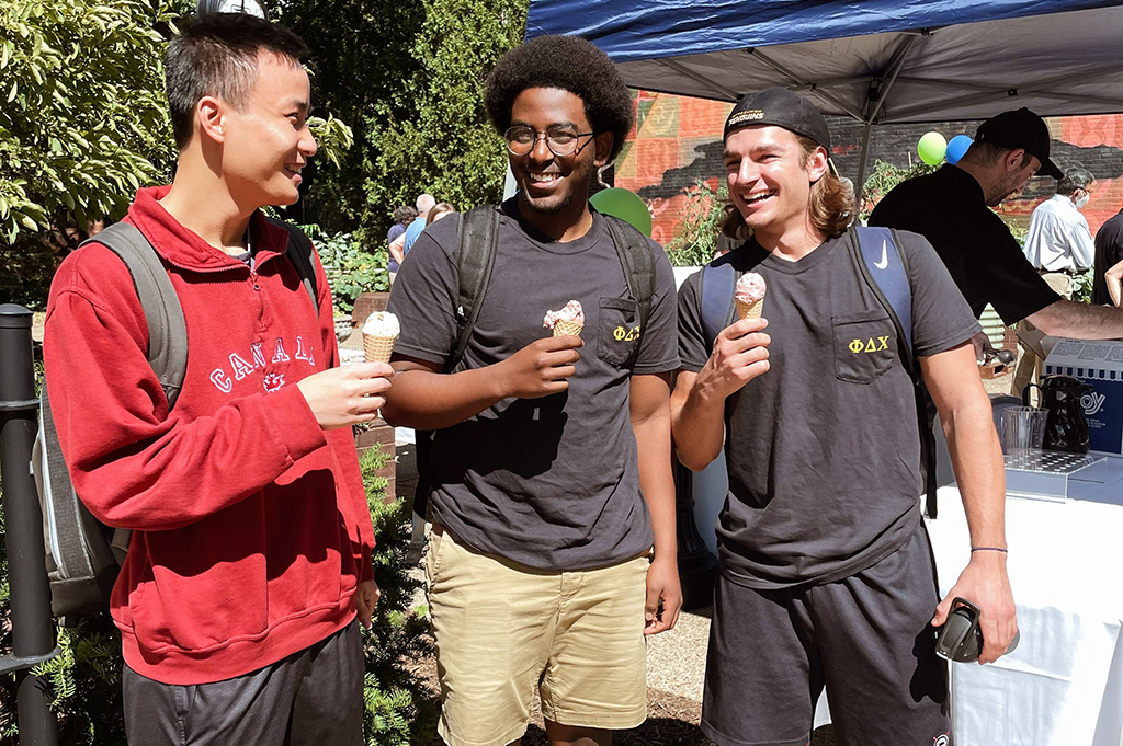 three students having ice cream on a-walk