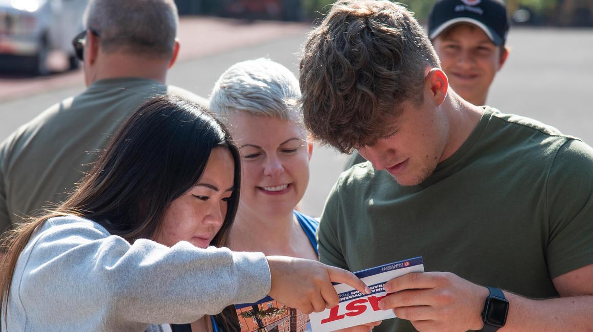 Duquesne family at FAST 2023 looking at a map