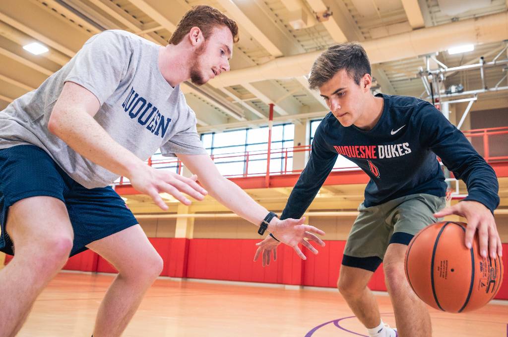 2 men playing basketball