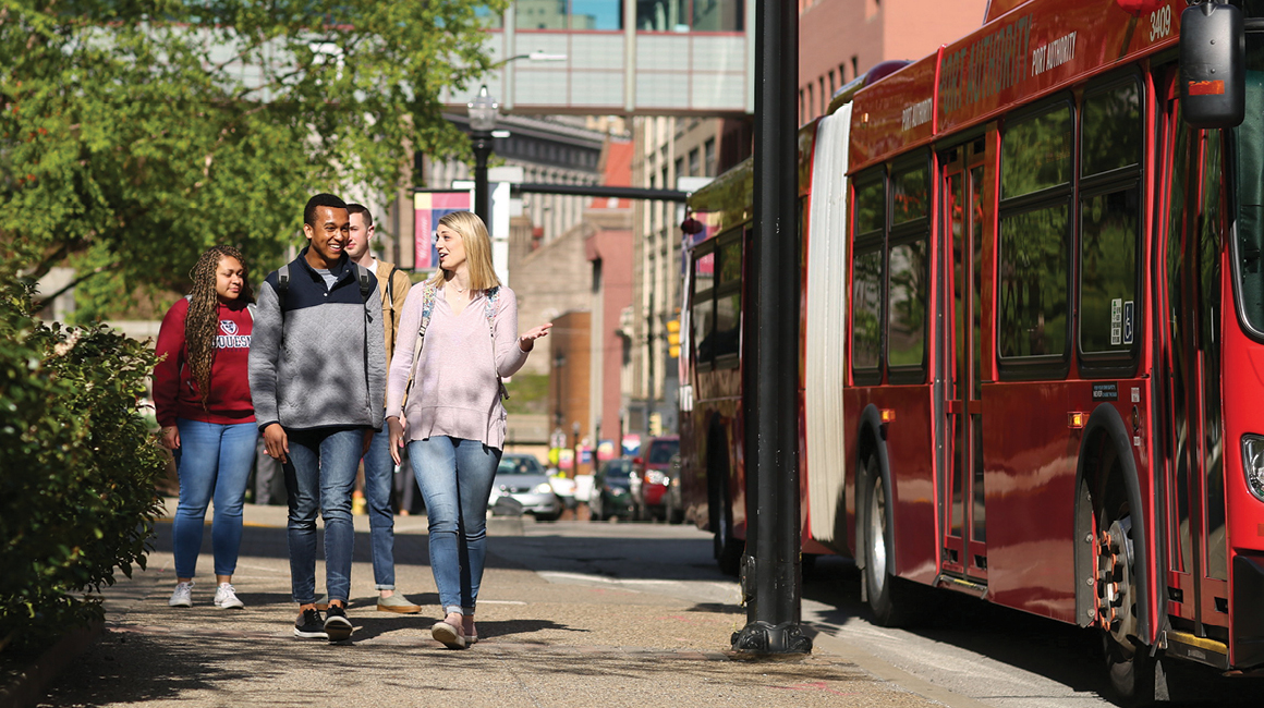 commuters walking near a bus