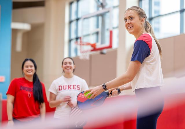 3 Duquesne students play pickleball in the Power Center.