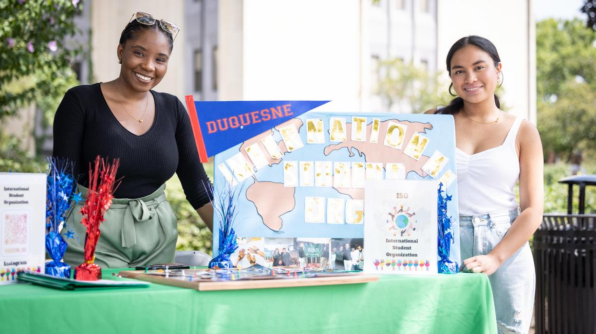 Students standng at international student organization table