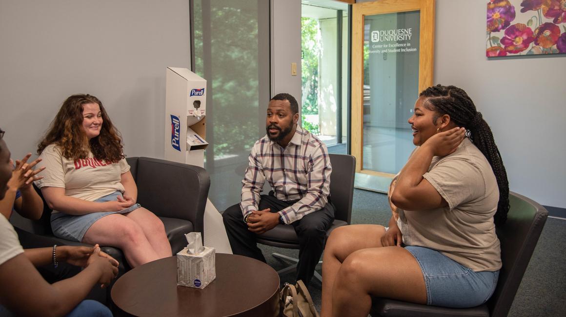 Students sitting in chairs talking